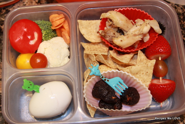 cheese, veggies, chips, chicken, figs, fresh fruit, and hard boiled egg. 